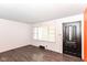 Bright living room features wood-look floors, a large window, and freshly painted walls at 1700 N Tibbs Ave, Indianapolis, IN 46222