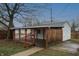 Detached one-car garage and covered parking offering additional storage and parking spaces at 1957 N Colorado Ave, Indianapolis, IN 46218