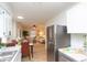 Bright kitchen featuring stainless steel refrigerator and seamless flow into the living area at 1957 N Colorado Ave, Indianapolis, IN 46218