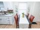 Bright eat-in kitchen with white cabinetry, modern countertops, and stylish red chairs at 1957 N Colorado Ave, Indianapolis, IN 46218