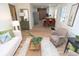 Bright living room with wood floors flowing into an open kitchen and dining area at 1957 N Colorado Ave, Indianapolis, IN 46218