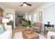 Bright living room featuring an open floor plan flowing into an adjacent kitchen and dining area at 1957 N Colorado Ave, Indianapolis, IN 46218