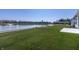 Serene backyard with a lake featuring a fountain, with lush green grass and charming landscaping at 19771 Sutton Ter, Westfield, IN 46074