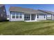 View of the backyard featuring a covered patio and lush green lawn at 19771 Sutton Ter, Westfield, IN 46074