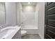 Well-lit bathroom featuring a single vanity with quartz countertop and tub with shower combo at 19771 Sutton Ter, Westfield, IN 46074