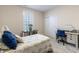 Bright bedroom with a cozy bed, natural light from a window, a desk with chair, and closet with sliding doors at 19771 Sutton Ter, Westfield, IN 46074