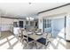 Dining area with a view to the kitchen with light wood table set and slider doors to backyard at 19771 Sutton Ter, Westfield, IN 46074