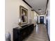 Hallway featuring wood floors and a console table with artwork, adding character to the home at 19771 Sutton Ter, Westfield, IN 46074