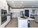 Beautiful, bright kitchen with stainless appliances, a center island and white shaker cabinets at 19771 Sutton Ter, Westfield, IN 46074