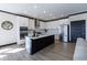Well-lit kitchen featuring a center island, white cabinets, and stainless steel appliances at 19771 Sutton Ter, Westfield, IN 46074