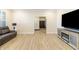 Open-concept living room with a modern entertainment center, comfortable sofa, and a view into another room at 19771 Sutton Ter, Westfield, IN 46074