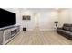 Cozy living room with wood floors, television, fireplace, and comfortable leather couch at 19771 Sutton Ter, Westfield, IN 46074