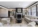 Comfortable living room featuring a fireplace, display cabinets and ample seating at 19771 Sutton Ter, Westfield, IN 46074