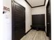 Stylish mud room with black accents, coat hooks, bench, and storage for organization at 19771 Sutton Ter, Westfield, IN 46074