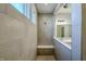 Modern, tiled shower with built-in bench seat, natural light from two windows, and sleek fixtures at 19771 Sutton Ter, Westfield, IN 46074