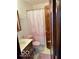 Modest bathroom with pink toilet seat cover and pink patterned shower curtain at 2359 S County Road 1050 E, Indianapolis, IN 46231
