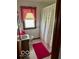 Modest bathroom with pink rug, shower curtain and window coverings at 2359 S County Road 1050 E, Indianapolis, IN 46231