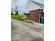 Brick home featuring a covered porch and an adjacent paved driveway at 2359 S County Road 1050 E, Indianapolis, IN 46231