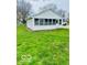 Charming home featuring a bright white exterior and beautiful landscaping, creating a welcoming curb appeal at 2359 S County Road 1050 E, Indianapolis, IN 46231