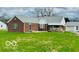 Charming red brick single-story home with well-maintained lawn and detached two-car garage at 2359 S County Road 1050 E, Indianapolis, IN 46231