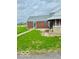 Quaint brick home with a covered porch and green lawn at 2359 S County Road 1050 E, Indianapolis, IN 46231