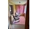 Bright sun room with a pink rug, rocking chairs, and curtains at 2359 S County Road 1050 E, Indianapolis, IN 46231