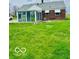 Brick house with a sunroom addition and grassy lawn at 2359 S County Road 1050 E, Indianapolis, IN 46231
