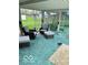 Cozy sunroom featuring comfortable seating, a plush blue carpet, and plenty of natural light at 2359 S County Road 1050 E, Indianapolis, IN 46231