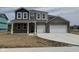 Two-story home with a two-car garage, stone facade, and covered front porch at 240 Ames Dr, Whiteland, IN 46184