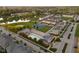 Aerial view of a neighborhood featuring townhomes, a pool, tennis courts, a baseball field, and a small lake at 2618 Congress St, Carmel, IN 46032
