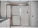 Bathroom featuring a glass shower and white subway tiles with a granite countertop sink at 2618 Congress St, Carmel, IN 46032