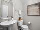 Chic powder room featuring a pedestal sink, updated fixtures, and stylish decor at 2618 Congress St, Carmel, IN 46032