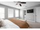 Spacious primary bedroom features plush carpeting, ceiling fan, and ensuite bathroom at 2618 Congress St, Carmel, IN 46032