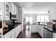 Gourmet kitchen with stainless steel appliances, black subway tile backsplash, and breakfast nook in view at 2618 Congress St, Carmel, IN 46032