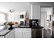 Modern kitchen with black countertops, stainless steel appliances, and open floor plan to the living room at 2618 Congress St, Carmel, IN 46032