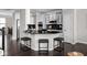 Modern kitchen boasts sleek black countertops, white cabinets, and a cozy breakfast bar area at 2618 Congress St, Carmel, IN 46032