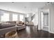 Bright living room with dark hardwood floors, neutral walls, and comfortable seating arrangement near the staircase at 2618 Congress St, Carmel, IN 46032