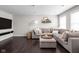 Inviting living room featuring a large sectional sofa, dark hardwood floors and contemporary decor at 2618 Congress St, Carmel, IN 46032