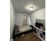 Bedroom showcasing a simple bed, dark wood trim, and a large window at 2627 Chase St, Anderson, IN 46016