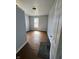 A standard bedroom features wood floors, grey walls, a window, and a light at 2627 Chase St, Anderson, IN 46016