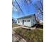 Charming one-story home with light green siding, white trim, and a cozy front porch and walkway at 2627 Chase St, Anderson, IN 46016
