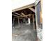 Garage interior with wooden beams and support, with an open doorway revealing sunlight at 2627 Chase St, Anderson, IN 46016