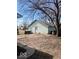 Detached garage with light green siding, a practical space for parking or storage with yard behind at 2627 Chase St, Anderson, IN 46016