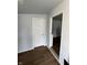 Hallway with brown wood-look flooring and neutral-colored walls, with a doorway to another room at 2627 Chase St, Anderson, IN 46016