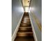 View looking up the staircase with painted grey walls and wooden rails at 2627 Chase St, Anderson, IN 46016
