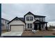 Two-story home features a two-car garage, black window shutters, and stone veneer accents near the foundation at 3246 Fawn Cir, Brownsburg, IN 46112