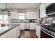 Modern kitchen featuring white cabinets, stainless steel appliances, granite countertops, and hardwood flooring at 3246 Fawn Cir, Brownsburg, IN 46112