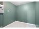 Basement features tiled floor, an electrical panel, and olive green walls at 3407 Allison Ave, Indianapolis, IN 46224