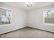 Bedroom with neutral carpet, two windows, and white walls at 3407 Allison Ave, Indianapolis, IN 46224