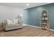 Cozy living room features new wood flooring, neutral walls and a decorative bookshelf at 3407 Allison Ave, Indianapolis, IN 46224